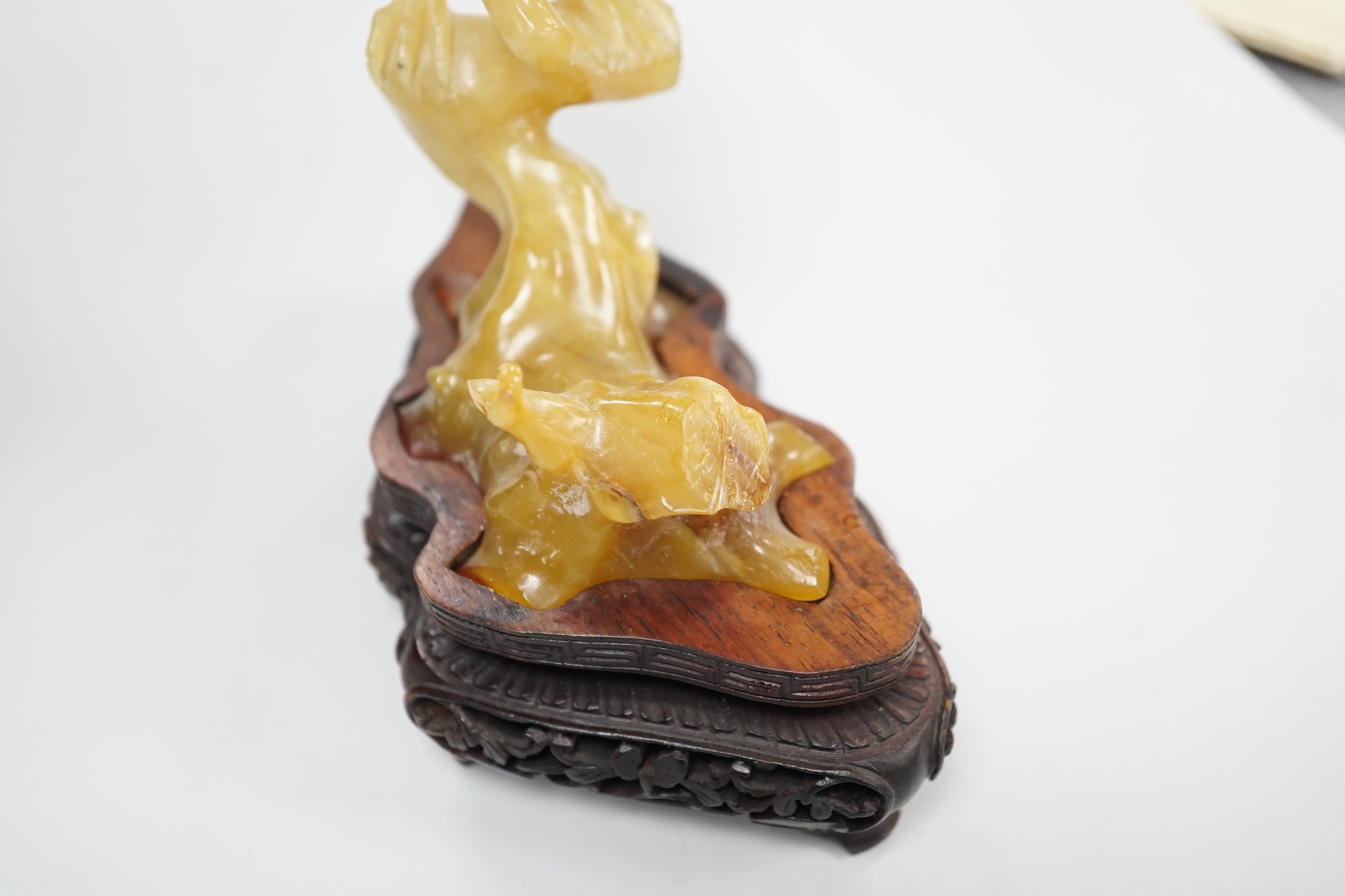 A Chinese chalcedony carving of a bird, wood stand, total height 15.5 cm